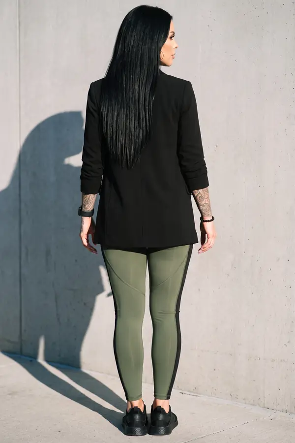back & profile: Black blazer over an olive sports top and panelled leggings