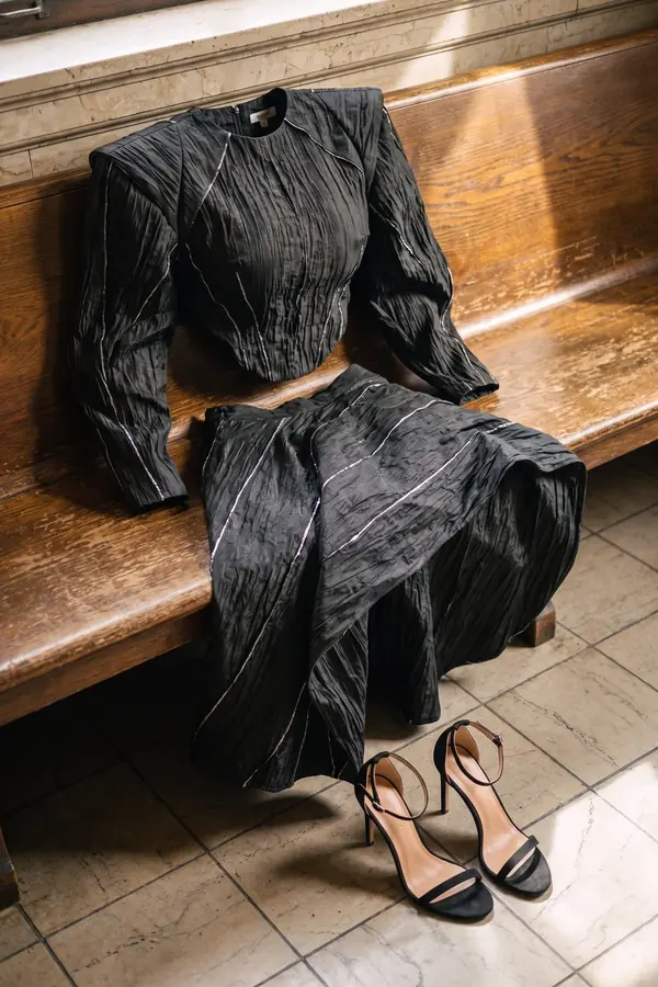 still life: Black crinkled taffeta top and skirt with silver piping