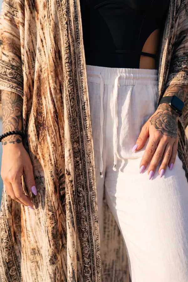 detail: Black cut-out bodysuit with white linen wide-leg trousers