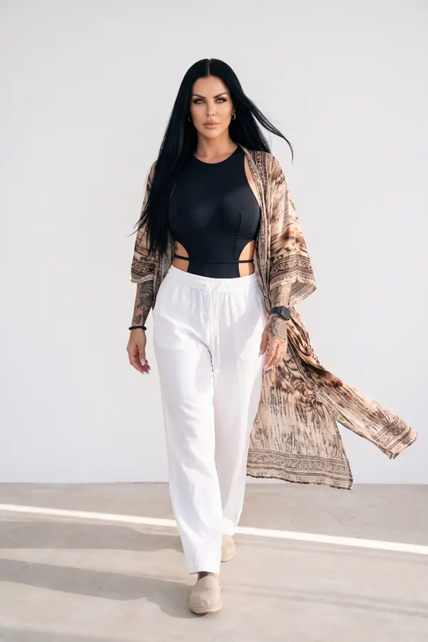 in motion: Black cut-out bodysuit with white linen wide-leg trousers