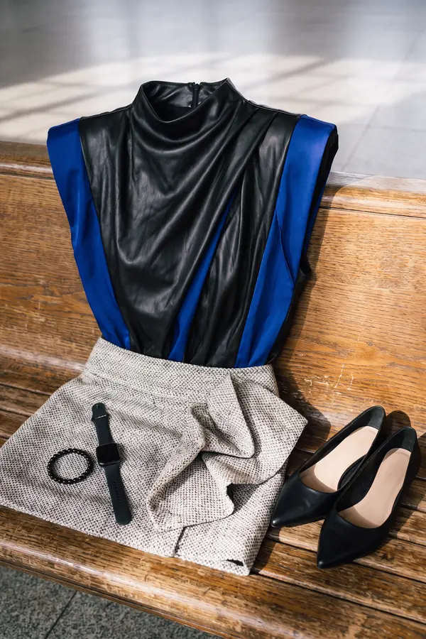 still life: Black leather top with cobalt panels and tweed mini skirt
