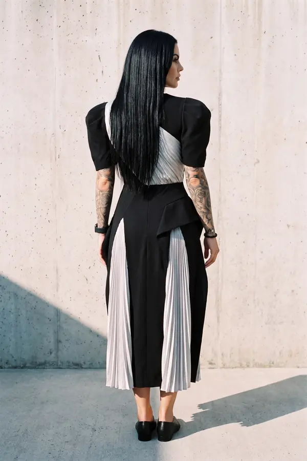 back & profile: Black puff-sleeve dress with pleated silver panels