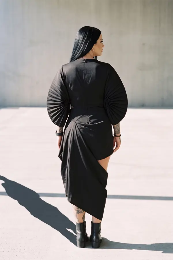 back & profile: Black satin cut-out dress with pleated fan sleeves