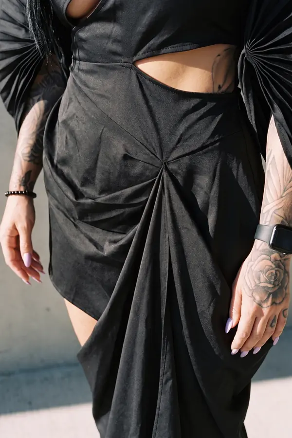 detail: Black satin cut-out dress with pleated fan sleeves