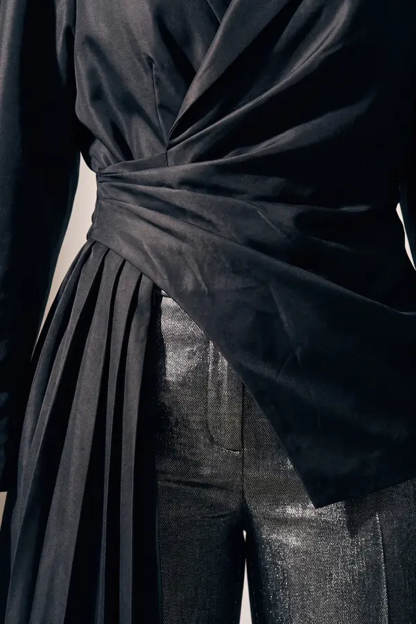 detail: Black taffeta wrap blouse with gunmetal wide trousers