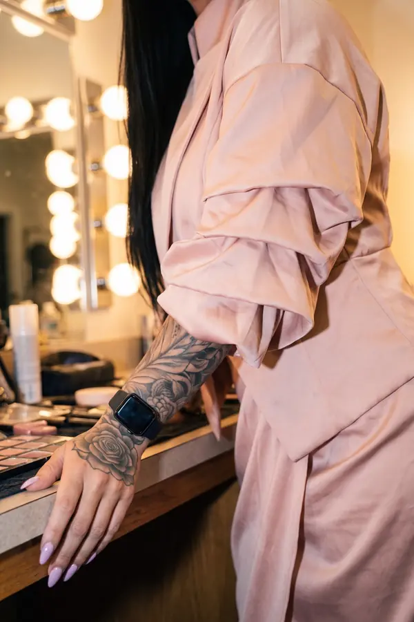 detail: Blush satin funnel-neck dress with ruched sleeves