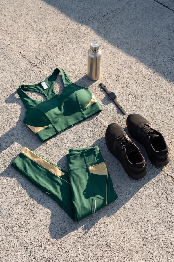 still life: Bottle-green sports top and leggings with gold panels