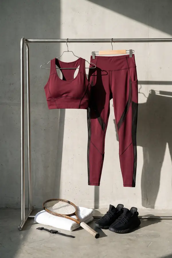 still life: Burgundy crop top and leggings with mesh panels