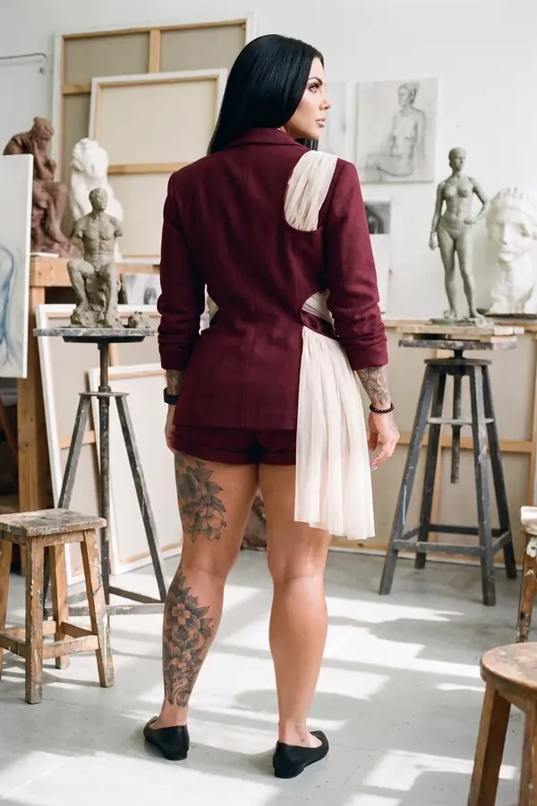 back & profile: Burgundy cut-out blazer with tulle sash and tailored shorts