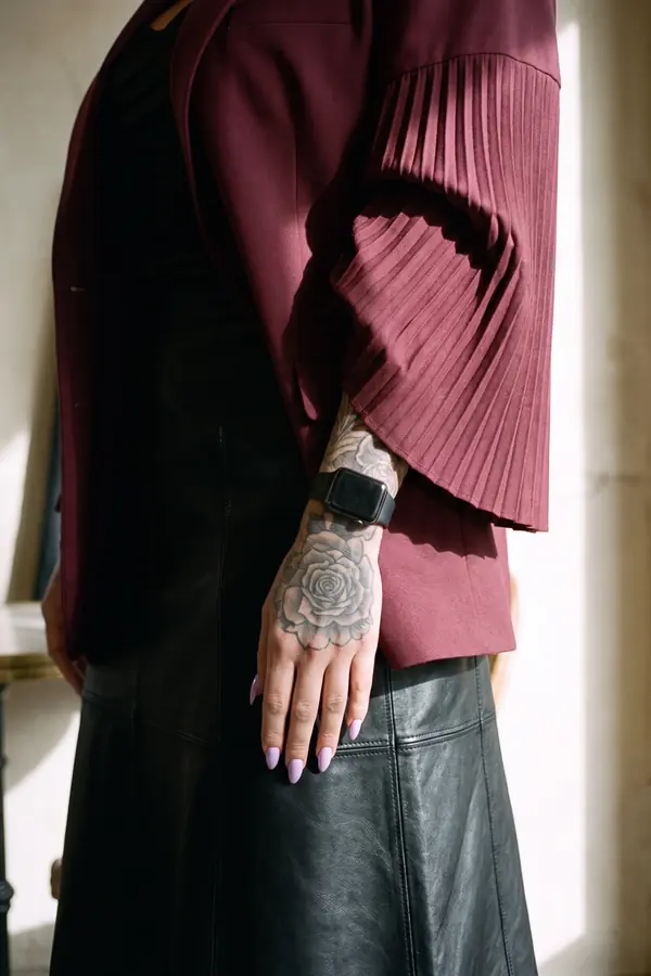 detail: Burgundy oversized blazer with a black leather midi skirt