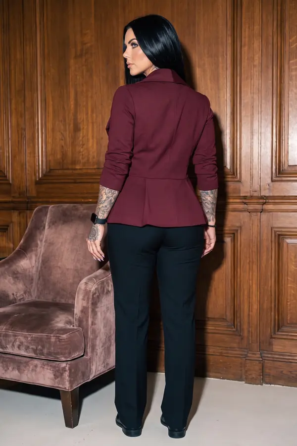 back & profile: Burgundy peplum blazer with satin blouse and black trousers