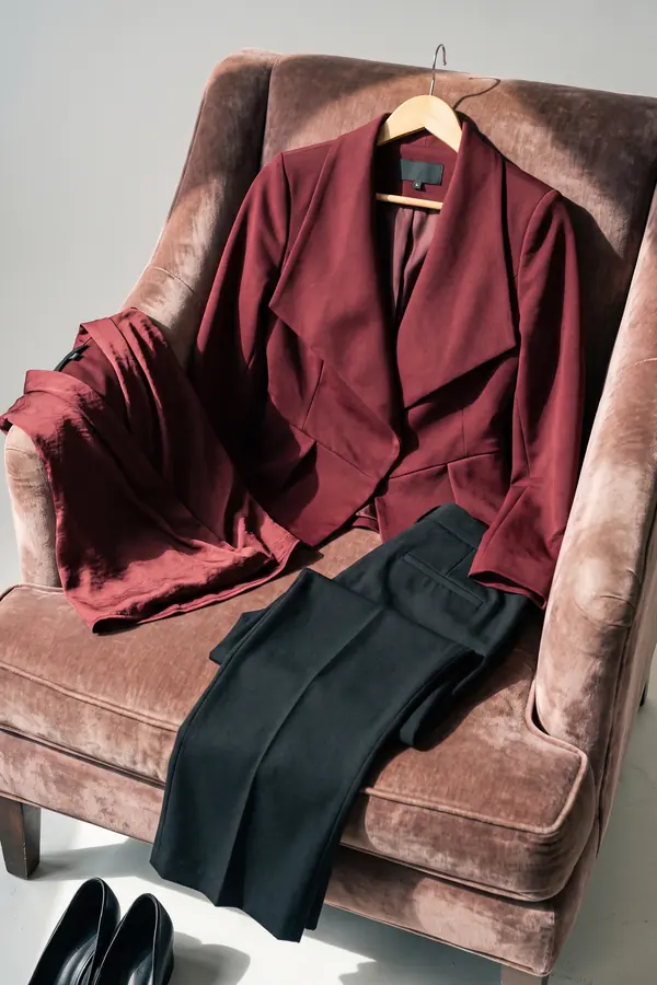 still life: Burgundy peplum blazer with satin blouse and black trousers