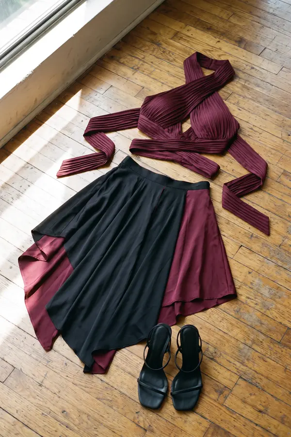 still life: Burgundy pleated crossover top and colour-block satin skirt