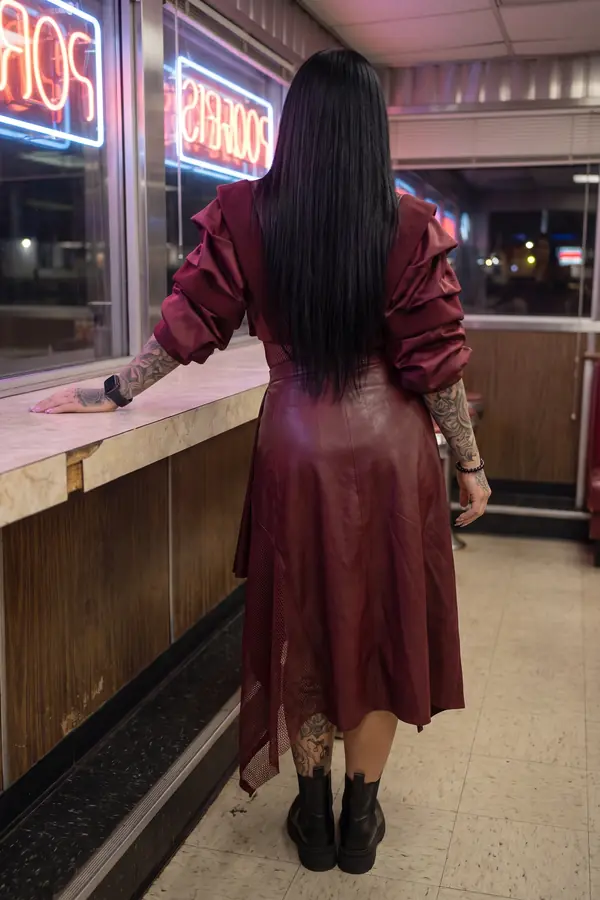 back & profile: Burgundy satin ruffle blazer with a leather and mesh skirt
