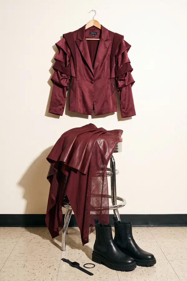 still life: Burgundy satin ruffle blazer with a leather and mesh skirt
