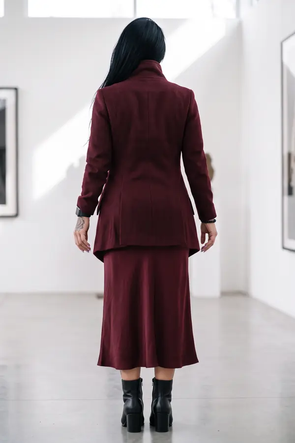 back & profile: Burgundy wool asymmetric coat over a satin midi skirt