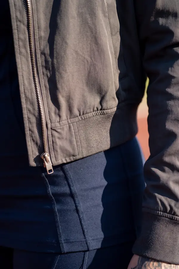 detail: Charcoal bomber over a navy fitted top and seamed leggings