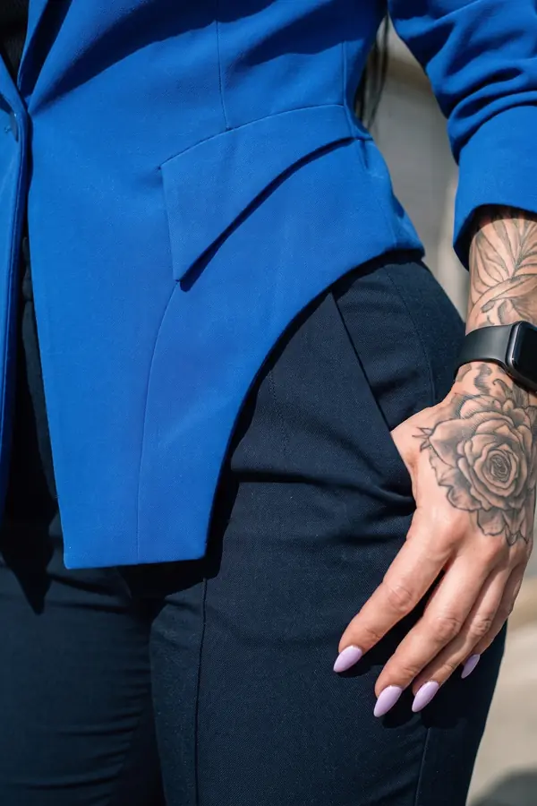 detail: Cobalt crepe blazer with a pointed hem and navy trousers