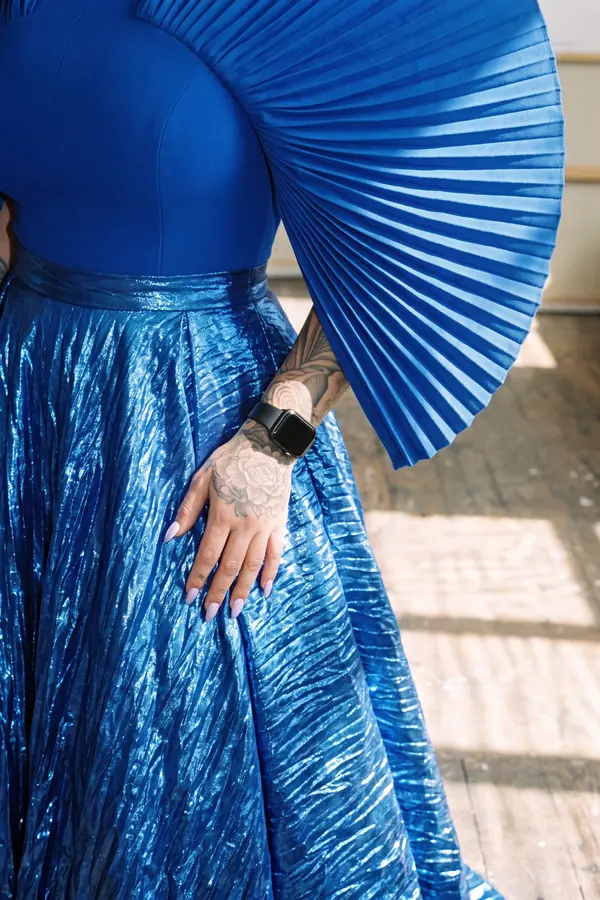 detail: Cobalt fan-sleeve top with metallic crinkle maxi skirt