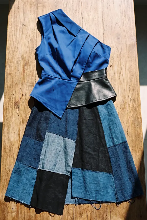 still life: Cobalt one-shoulder satin top with a patchwork denim skirt