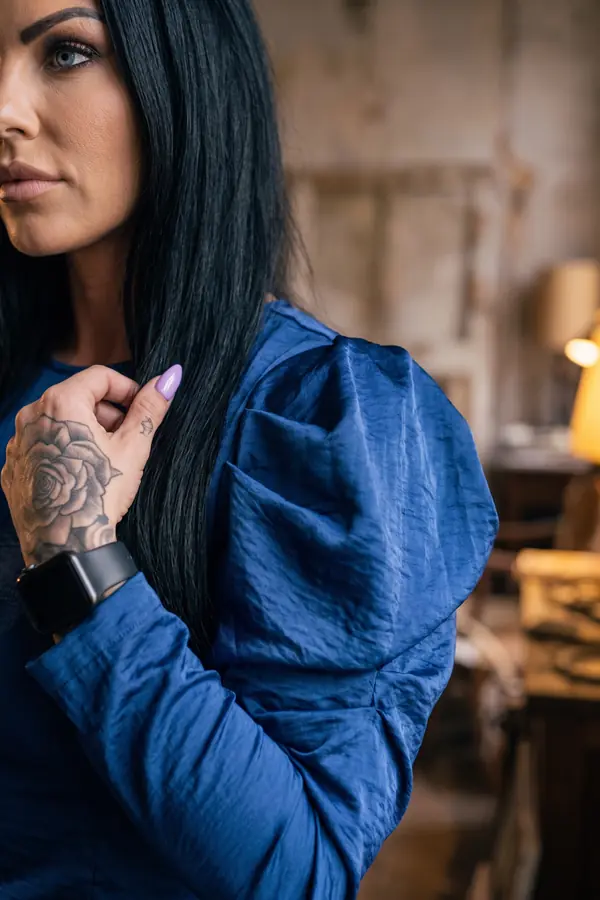 detail: Cobalt puff-sleeve satin blouse with black leather trousers