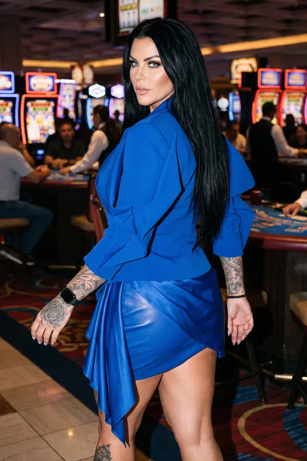 back & profile: Cobalt ruffle-back jacket with a draped leather mini skirt