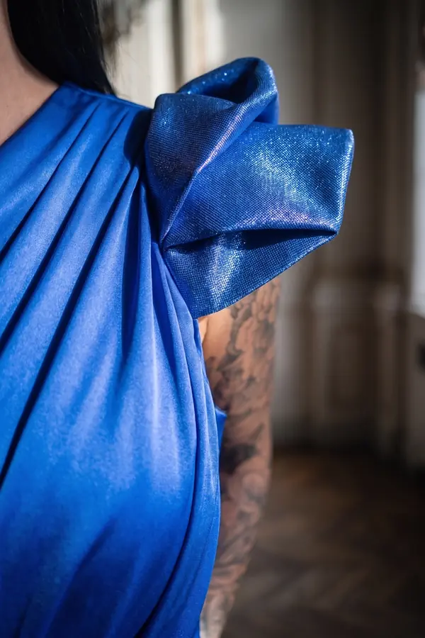 detail: Cobalt satin draped gown with structured bow shoulders