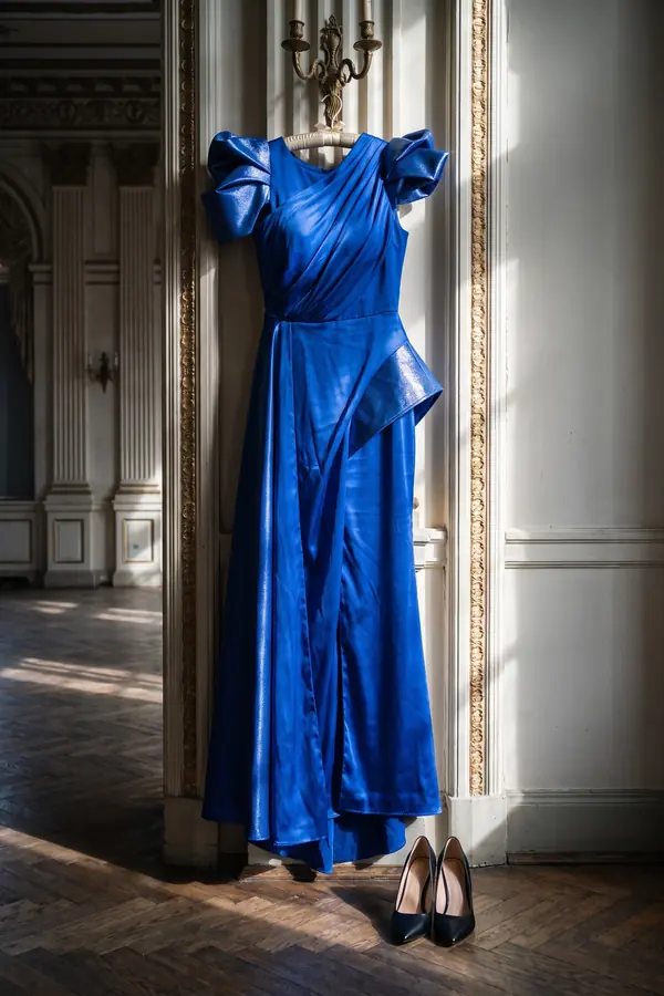 still life: Cobalt satin draped gown with structured bow shoulders