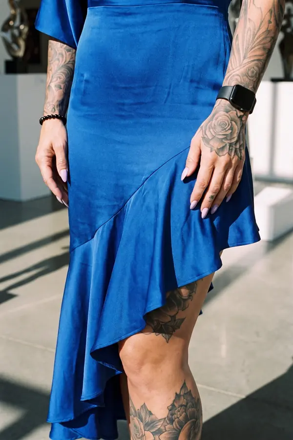 detail: Cobalt satin one-shoulder dress with a cape sleeve