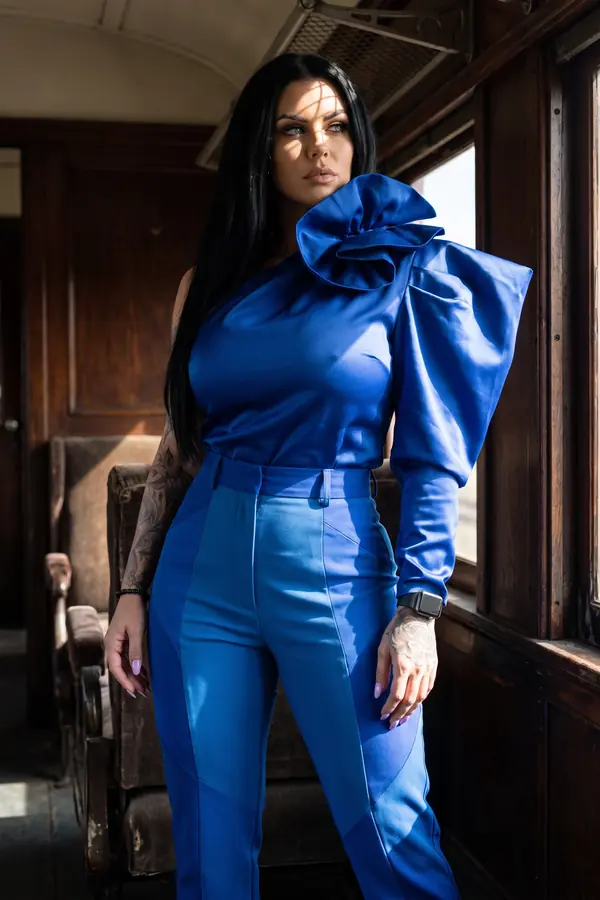 in motion: Cobalt satin rosette top with colour-block trousers