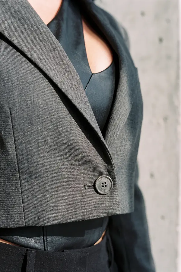 detail: Cropped blazer, leather cut-out top, mesh-panel trousers