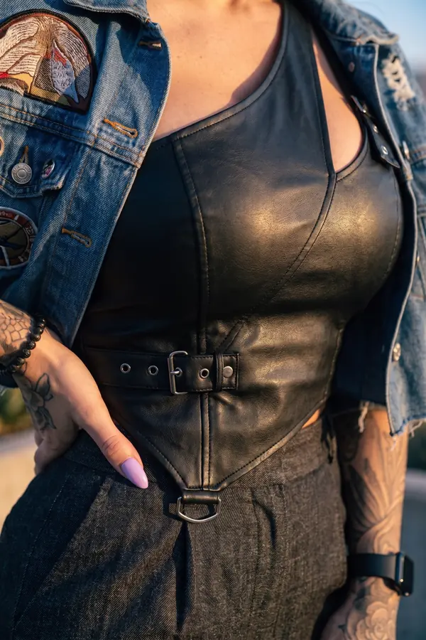 detail: Cropped denim jacket, leather bustier and wide-leg trousers