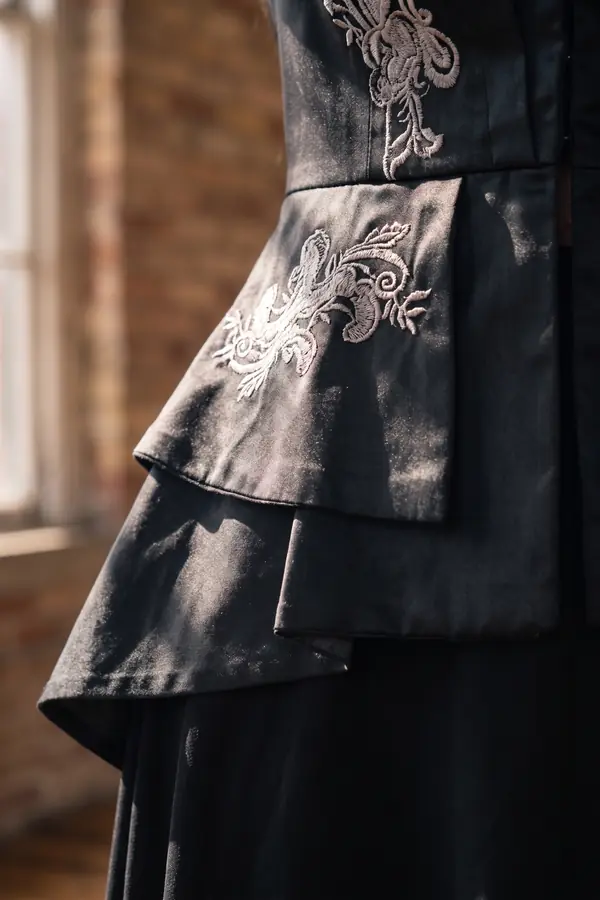 detail: Embroidered peplum jacket, high-low skirt and knee boots