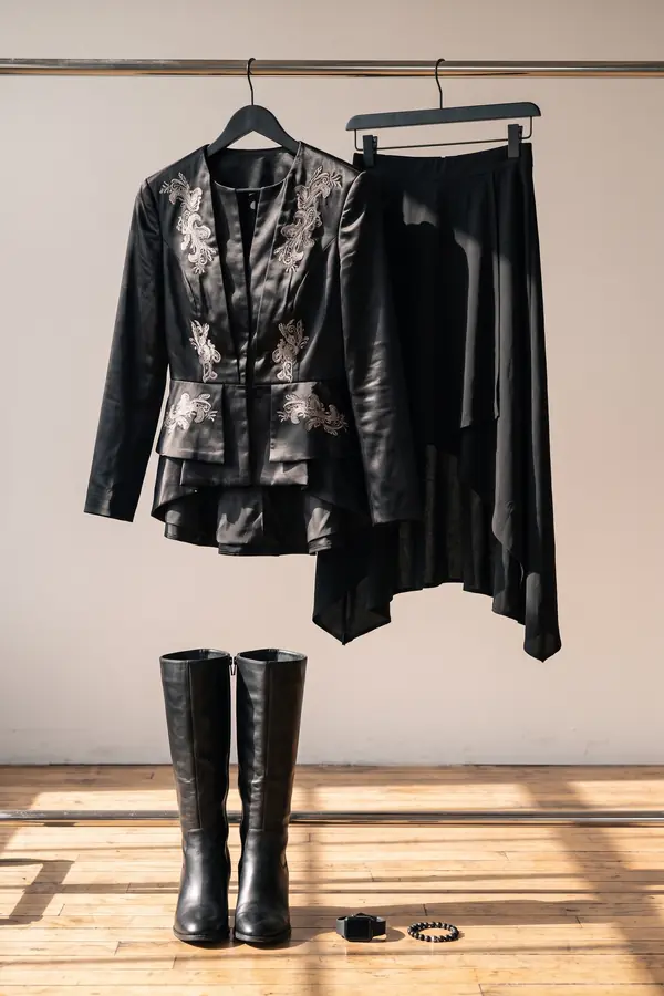still life: Embroidered peplum jacket, high-low skirt and knee boots