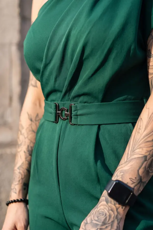 detail: Emerald one-shoulder draped jumpsuit with buckled belt