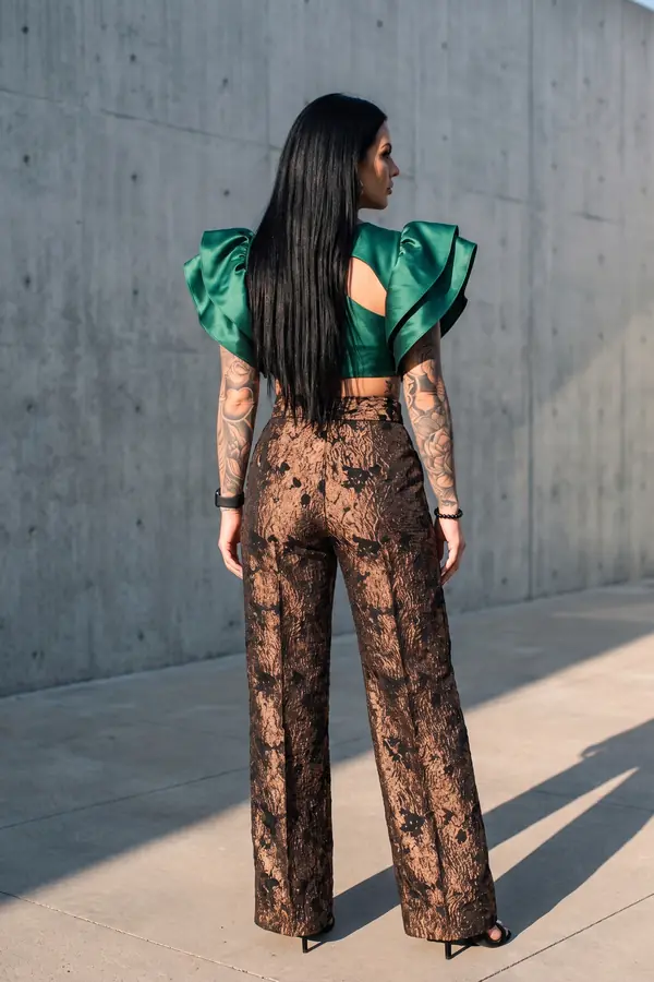 back & profile: Emerald ruffle cut-out top with bronze brocade trousers