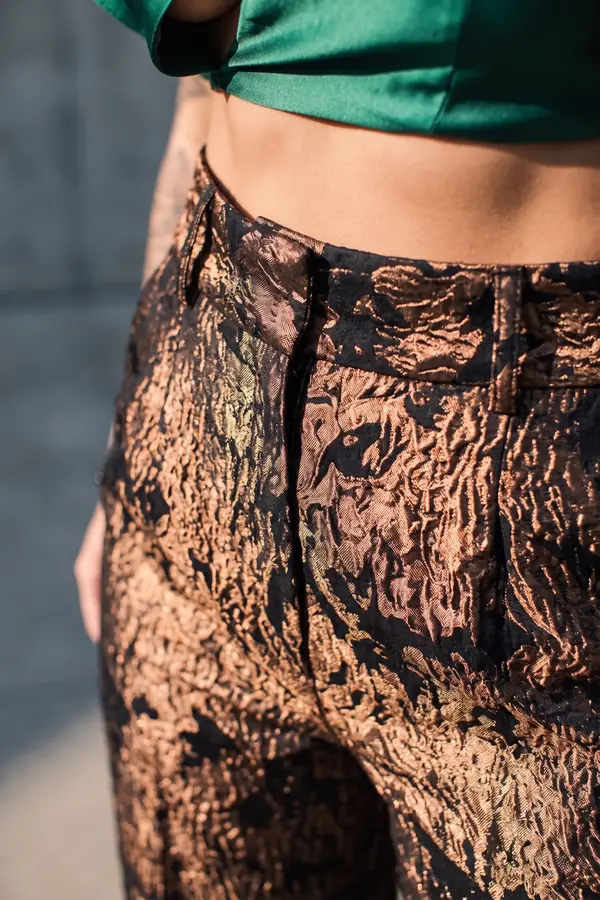 detail: Emerald ruffle cut-out top with bronze brocade trousers