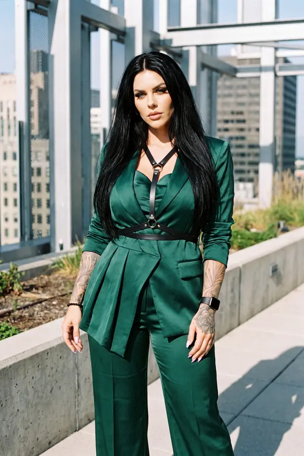 full look: Emerald satin suit with pleated peplum and O-ring strap belt
