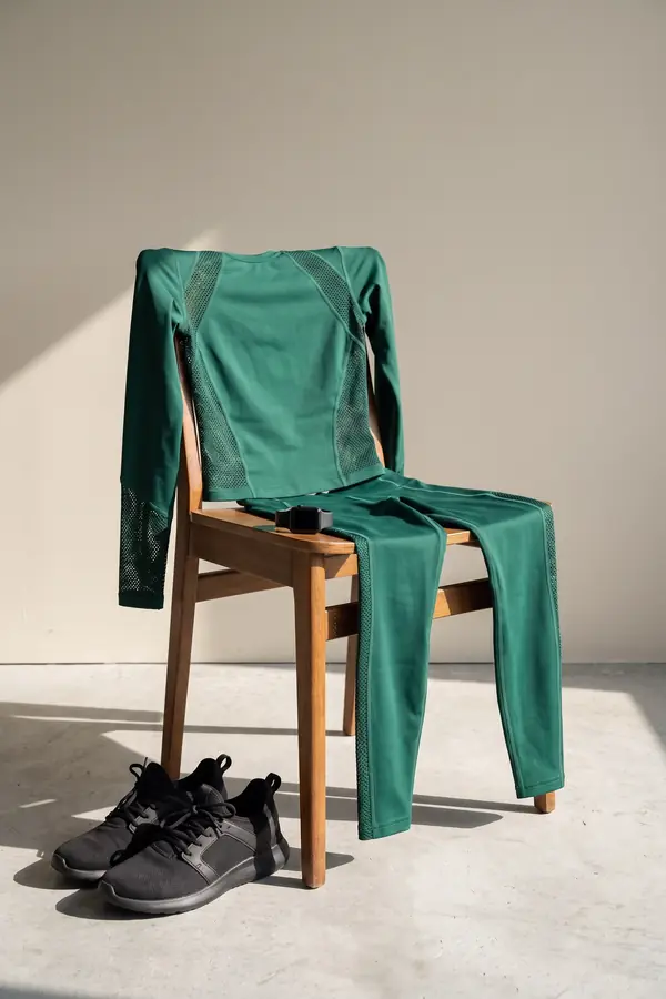 still life: Forest-green mesh-panel long-sleeve top and leggings