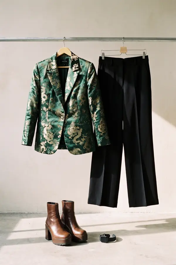 still life: Green and gold brocade blazer with black wide-leg trousers