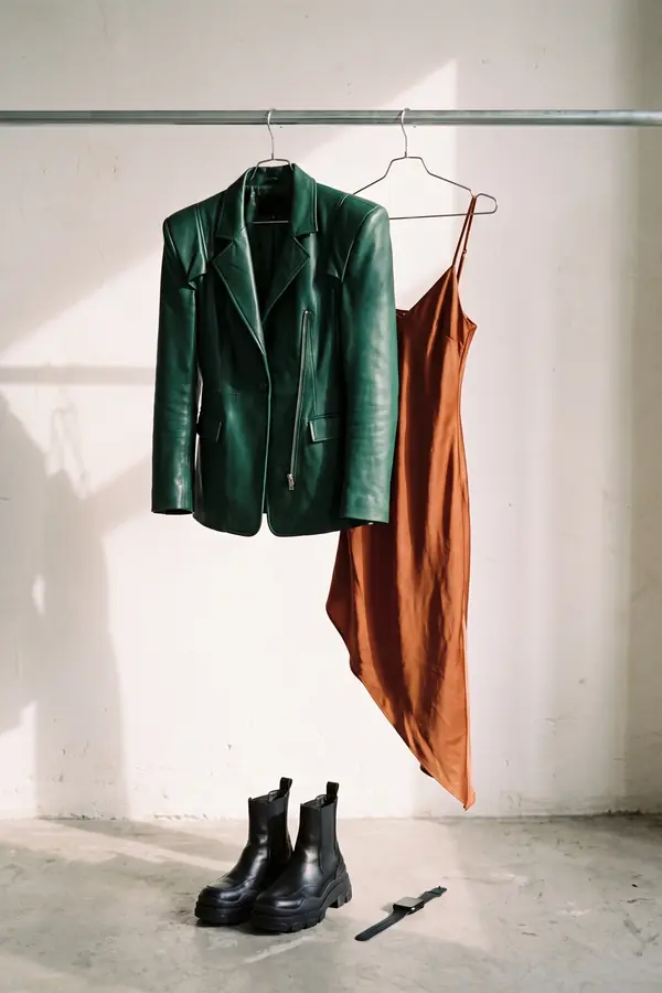 still life: Green leather blazer over a rust satin slip dress