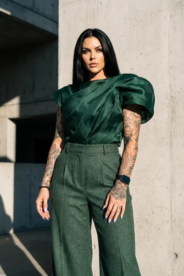 full look: Green satin draped top with wide-leg wool trousers