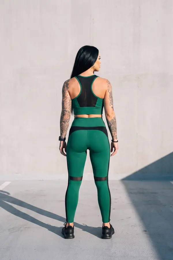 back & profile: Green sports top and leggings with black mesh panels