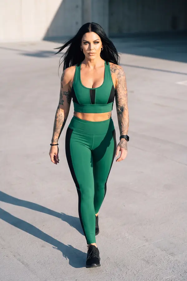 in motion: Green sports top and leggings with black mesh panels
