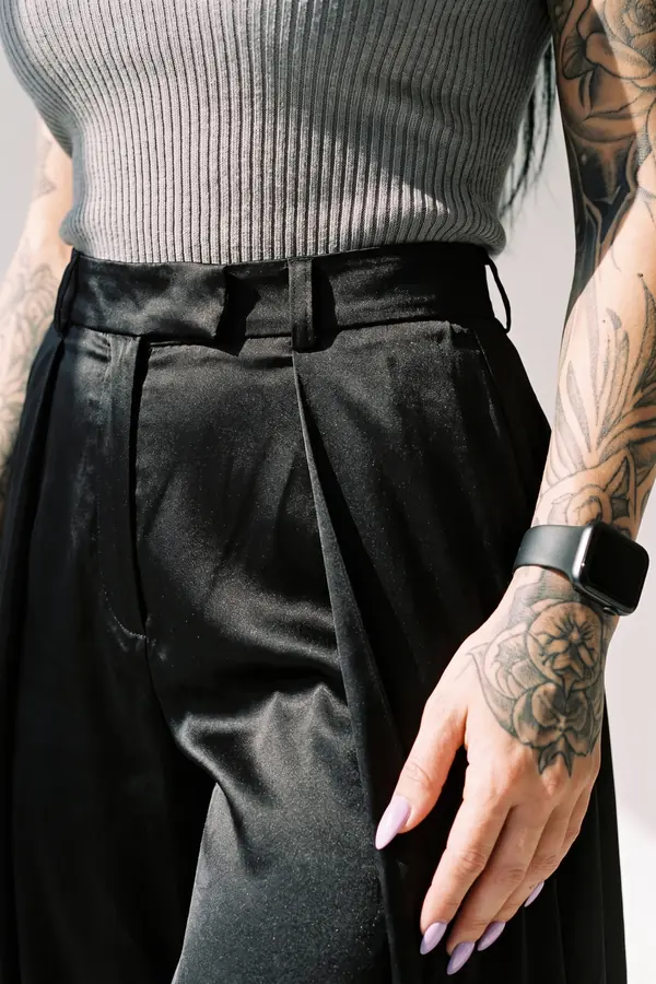 detail: Grey ribbed tank with satin wide-leg trousers and overskirt