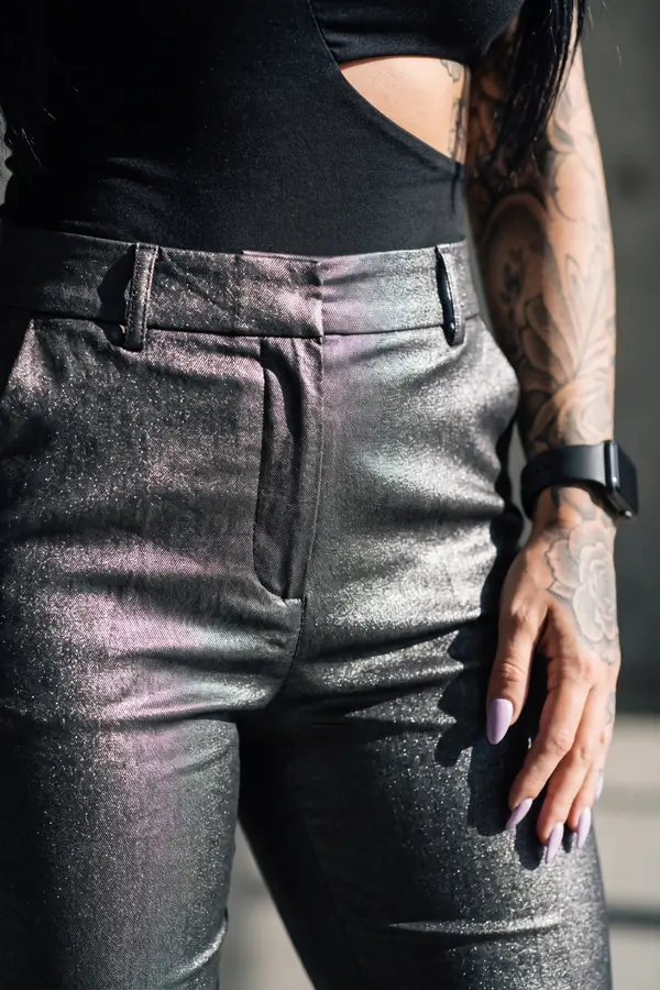 detail: Gunmetal metallic tapered trousers with a cut-out bodysuit