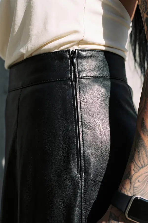 detail: Ivory cowl halter top with a black leather maxi skirt