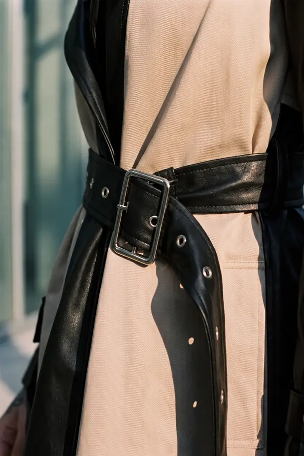 detail: Leather and satin trench coat with a pleated back panel