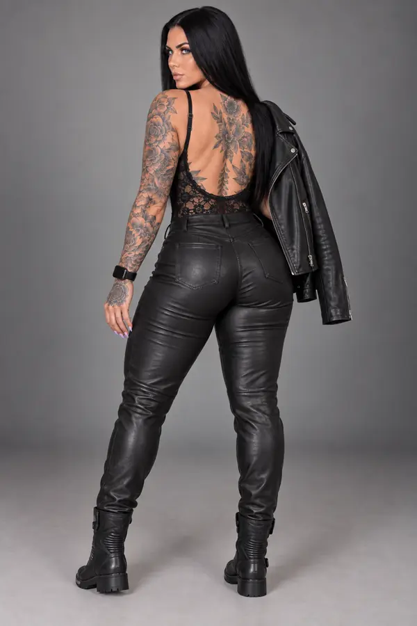 back & profile: Leather biker jacket, lace bustier and leather trousers