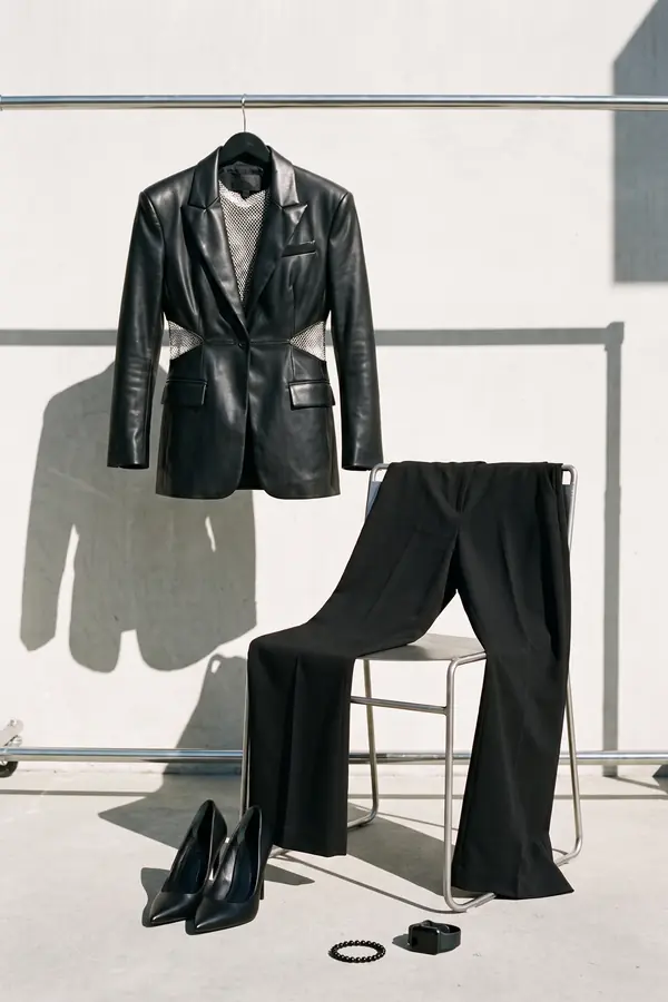still life: Leather blazer over a silver chainmail top and trousers